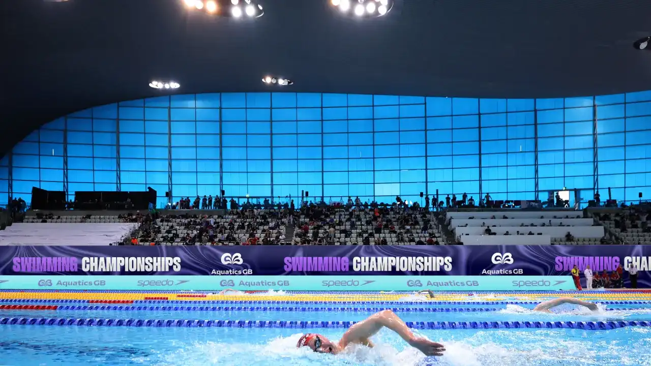 Swimmers racing in a pool at the Aquatics GB Swimming Championships